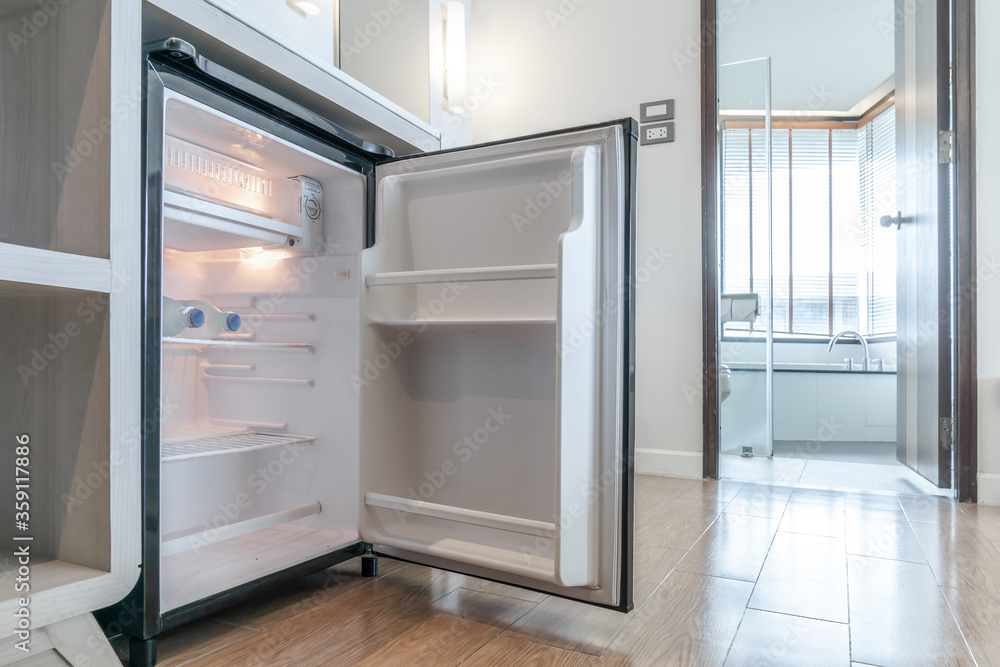 opened small refrigerator under the counter and in front of toilet in delux room at resort and hotel. opened small refrigerator under the counter and in front of toilet in delux room at resort and hotel.