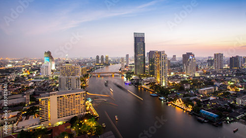 Bangkok Transportation at Dusk with Modern Business Building along the river