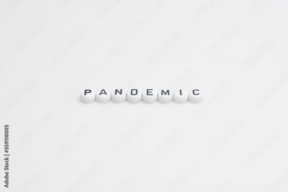 Fototapeta premium The word pandemic in small alphabetical beads, isolated over white