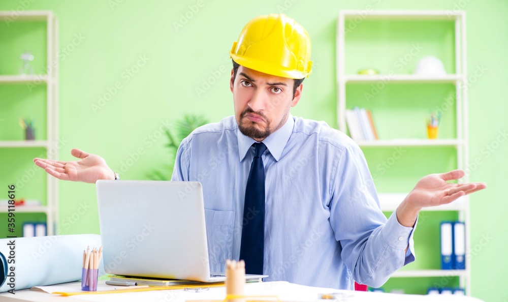 Young male architect working at the project Young male architect working at the project