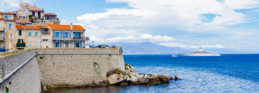 It's Old town of Antibes on the rock of the Mediterranean, Cote d'Azur, France. Antibes was founded as a 5th-century BC Greek colony and was called Antipolis - obrazy, fototapety, plakaty 