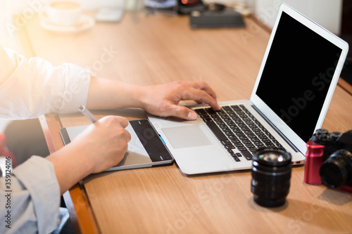Graphic Designer working with interactive pen display, digital Drawing tablet .Close up keyboard Laptop.