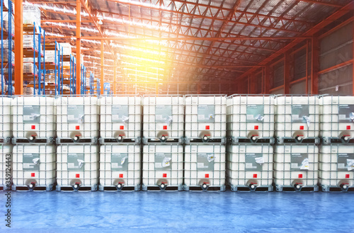 Liquid storage tank stack inside distribution warehouse. Industrial warehousing and logistics. Storage tank.