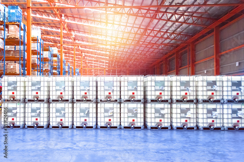 Liquid storage tank stack inside distribution warehouse. Industrial warehousing and logistics. Storage tank.