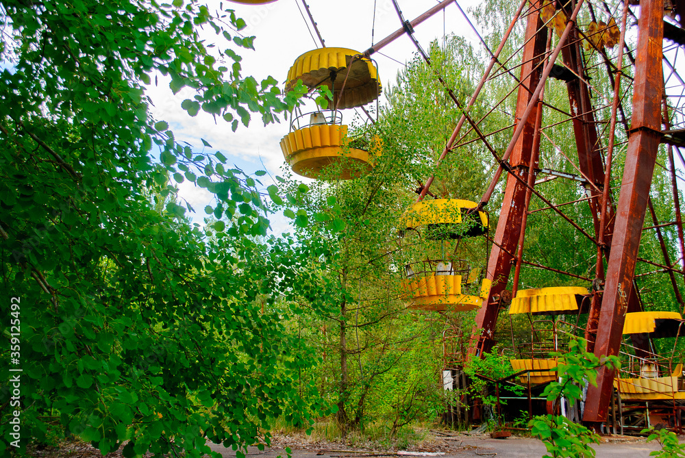 Observation wheel carousel with yellow cabins in the former musement ...