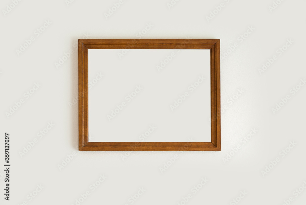 Empty wooden frame on a wall and white background Empty wooden frame on a wall and white background