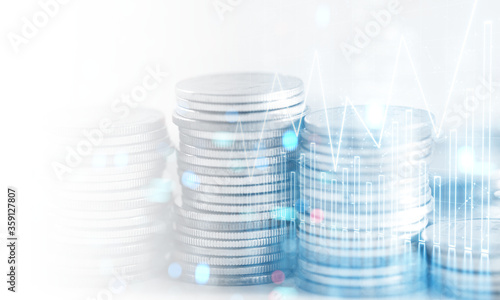 3D Rendering of stock candle charts with bokeh lights overlay of stack of coins. For business finance background