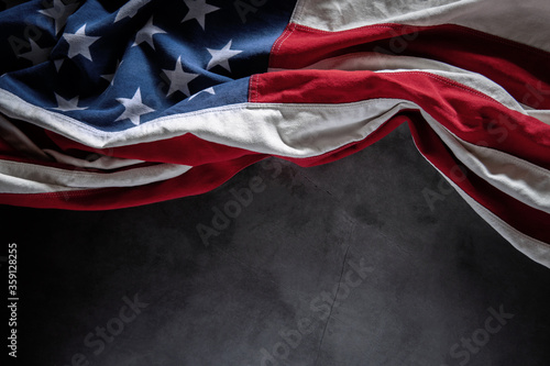 USA Flag Lying on Cement Background. American Symbolic. 4th of July or Memorial Day of United States. Copy Space for Text