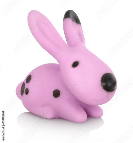 Stylish cute plastic pink rabbit toy. Isolated on white background with shadow reflection. With clipping path. Pink hare with black stains on white bg. Cape hare on white underlay. photo