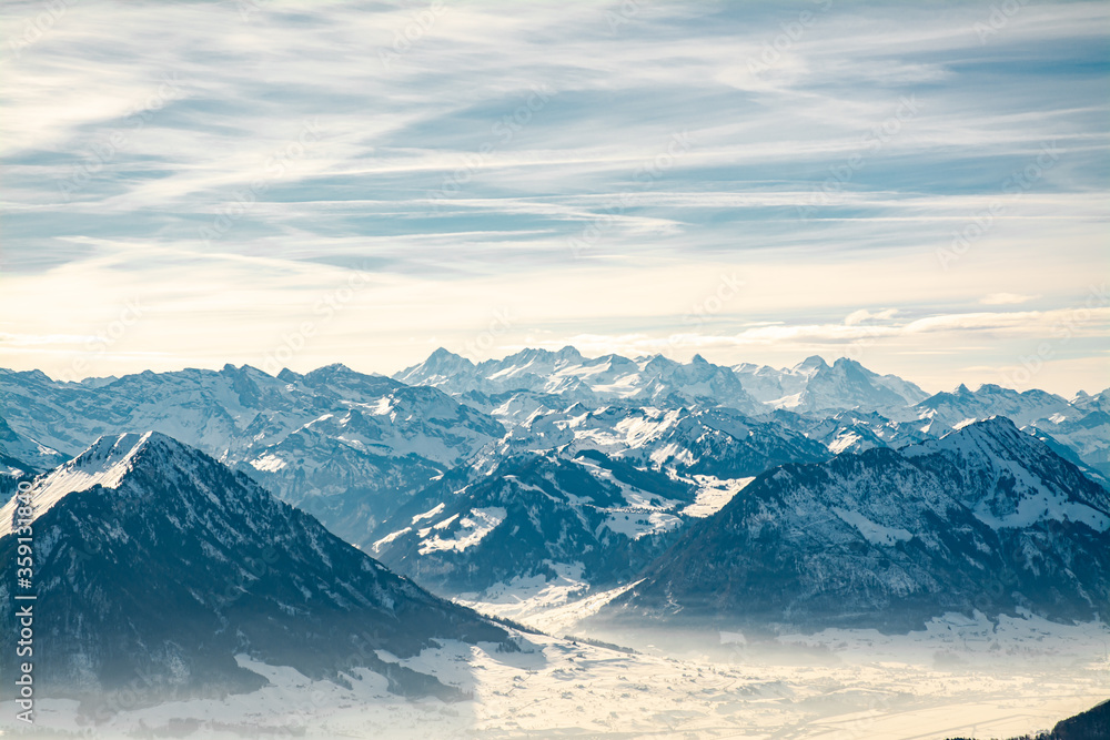 View of mountains range covered by snow in winter in Switzerland