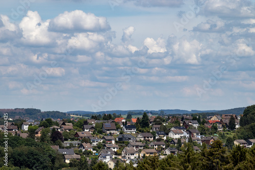 view over a village, rooftops, hills in the background
