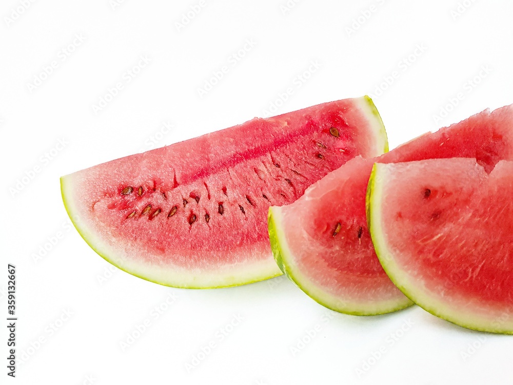 Bright juicy red watermelon cut into slices on a white background. Space for text. Bright juicy red watermelon cut into slices on a white background. Space for text.