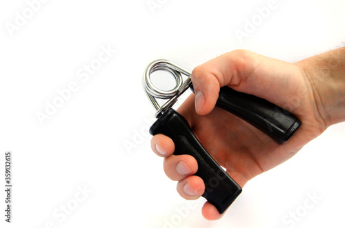 Expander finger trainer, finger workout tool on a white background close up.