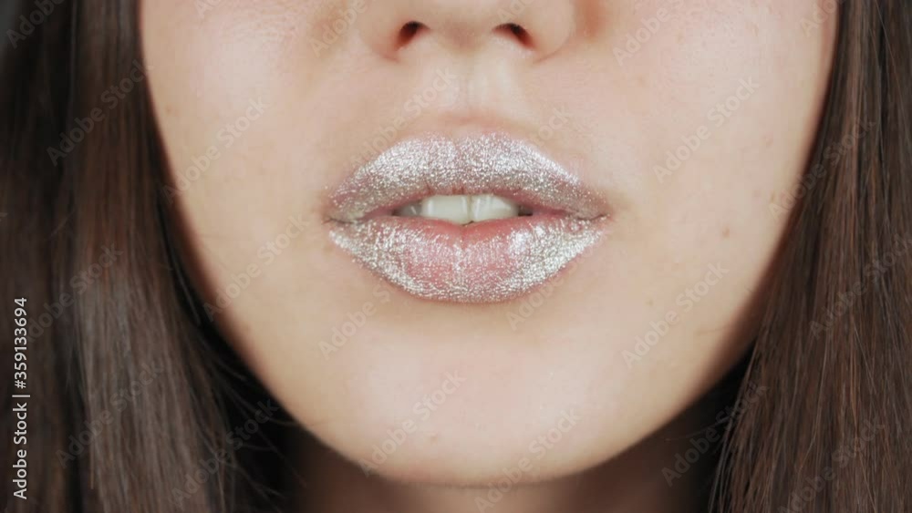 Fashion model woman lips in bright sparkles, beautiful sexy lips. Extreme close-up of full lips. Fashion model woman lips in bright sparkles, beautiful sexy lips. Extreme close-up of full lips.