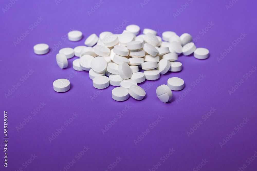 Round vitamins on purple background. Medical equipment necessary for public health and medicines. The cure for the virus. Vitamins from the virus. Various treatments mixed. Covid2019