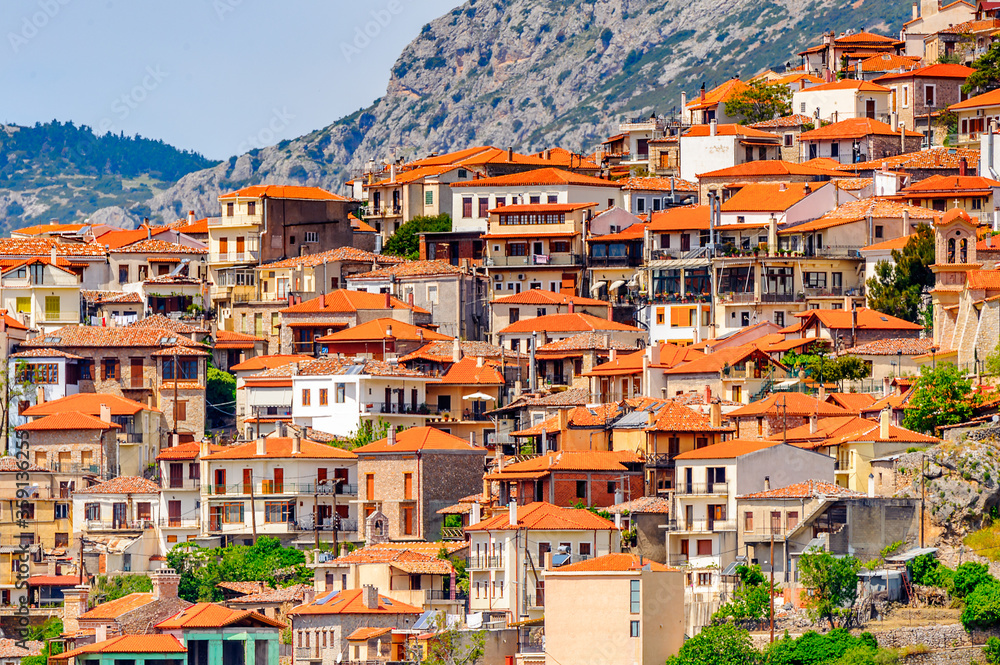 Obraz premium It's Houses of Arachova, Greece. A village on the green slopes of Parnassus Mountains, Greece