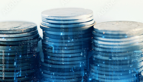 3D Rendering of futuristic city at night time overlay on stack of coins. Concept for business finance background