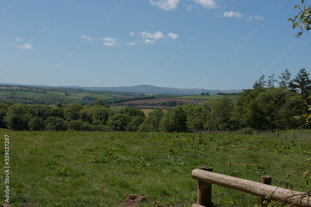 Rural Devon Countryside from Abbotsham Moor with Panoramic Views of the Peaks of Dartmoor National Park in the Background on a Sunny Spring Day in England, UK