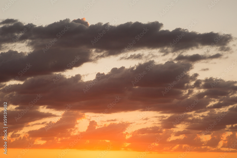 Naklejka premium Clouds at sunset. Beautiful sky with clouds on a warm summer evening