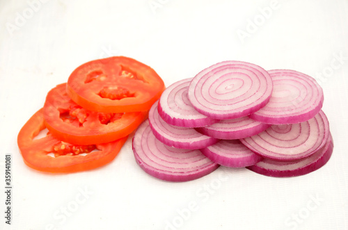 sliced red onion and tometo on cutting board photo