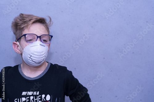 Child with face mask  smiling against COVI19 photo