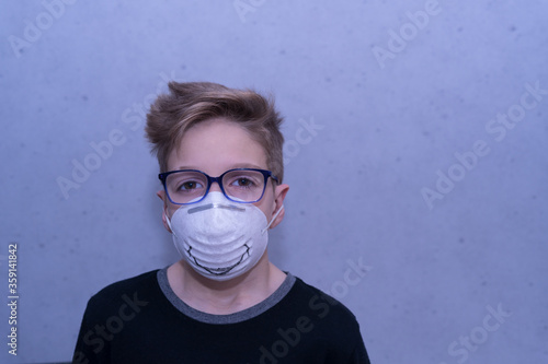 Child with face mask  smiling against COVI19 photo