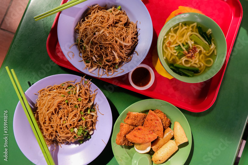 Popular local breakfast delights in Singapore — fried bee hoon, noodle soup, and fried snacks. Favourite hawker food; economical bee hoon, luncheon meat, fish cake, spam slices. Maxwell Food Centre