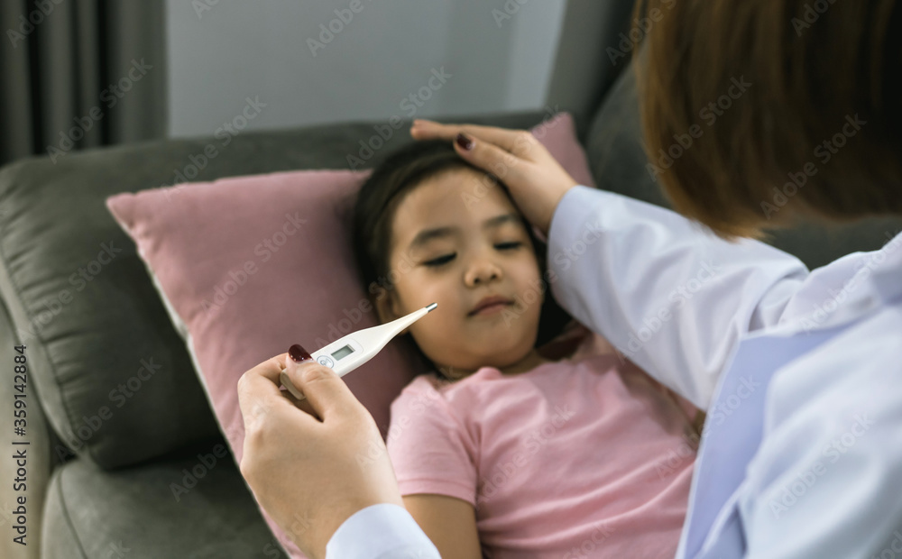 Asian female pediatrician is using a thermometer to measure fever for children Asian female pediatrician is using a thermometer to measure fever for children