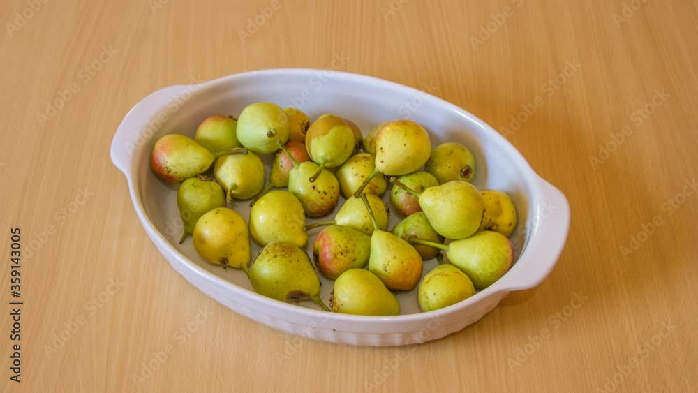 stop motion time lapse of pear fruits placed in a white ceramic baking dish that align and fill it completely stop motion time lapse of pear fruits placed in a white ceramic baking dish that align and fill it completely