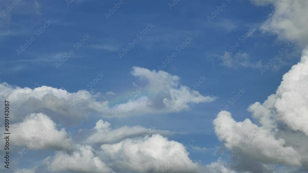 Rainbow on blue sky with flying rain cloud before raining Rainbow on blue sky with flying rain cloud before raining