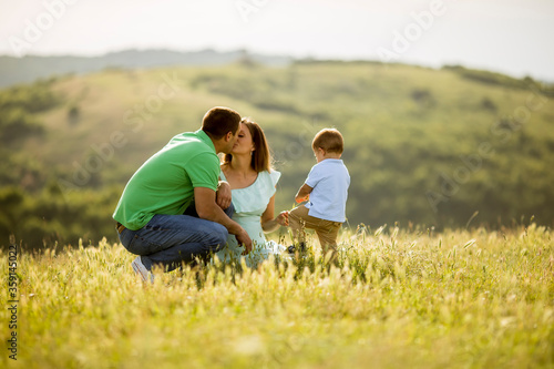 Young family having fun outdoors in the field