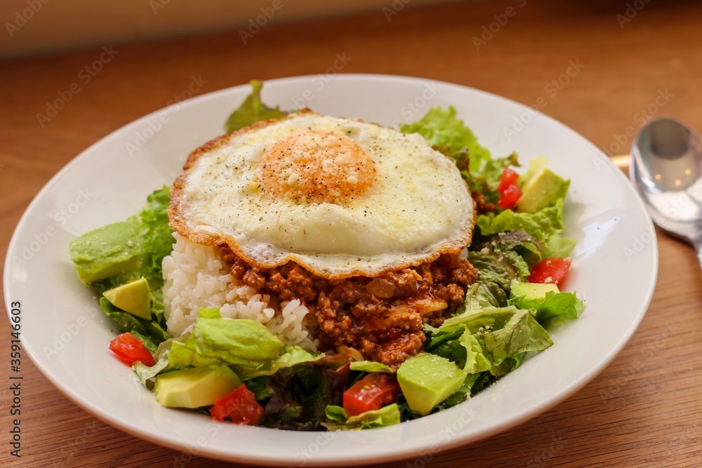 Taco rice, Japanese dish with meat, cheese and vegetables that originated in Okinawa. Taco rice, Japanese dish with meat, cheese and vegetables that originated in Okinawa.