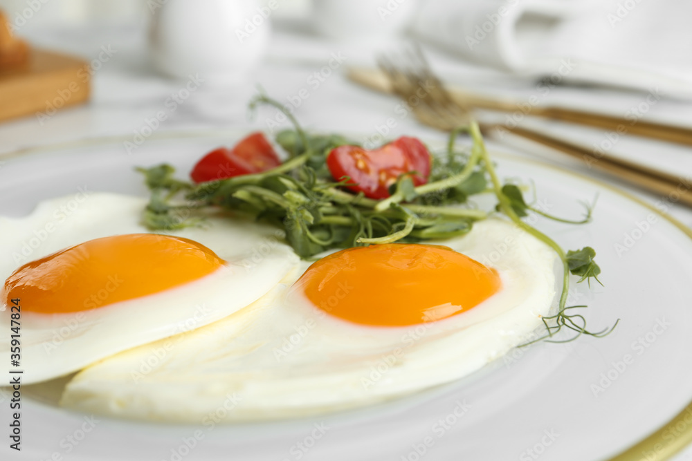 Tasty fried eggs with tomato and sprouts on plate, closeup Tasty fried eggs with tomato and sprouts on plate, closeup