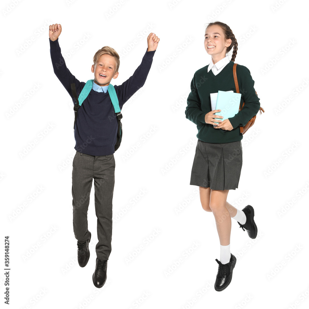 Children in school uniform jumping on white background Children in school uniform jumping on white background