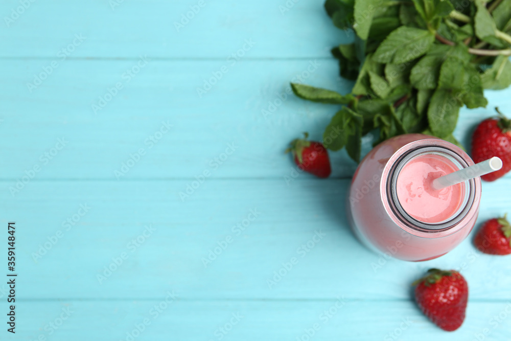 Tasty strawberry smoothie and mint on light blue wooden table, flat lay. Space for text Tasty strawberry smoothie and mint on light blue wooden table, flat lay. Space for text