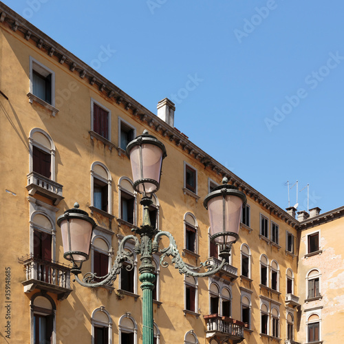 An rnate lampost and building in the backround on Campo San Geremia, Venice, Italy photo