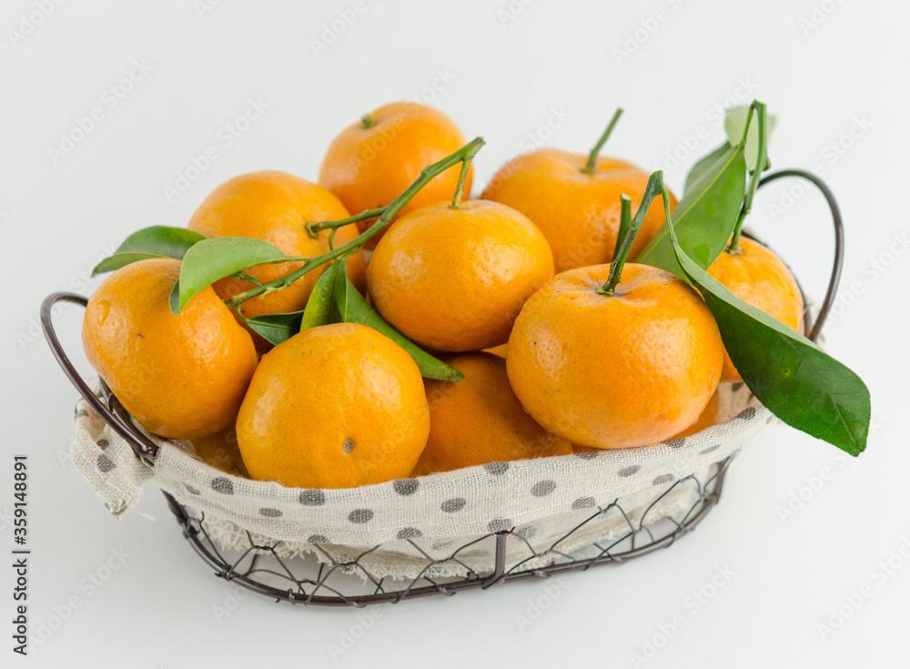 Fresh mandarin oranges fruit or tangerines with leaves on white background Fresh mandarin oranges fruit or tangerines with leaves on white background