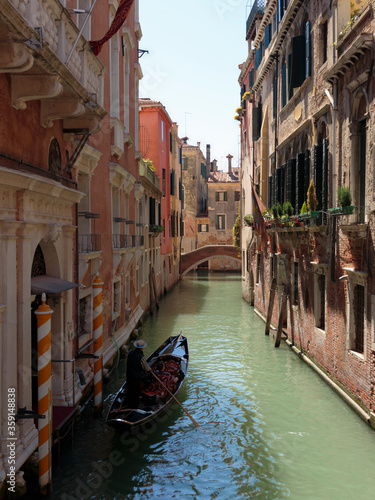 A gondola in the narrow passage of Cannaregio Canal, Venice, Italy
