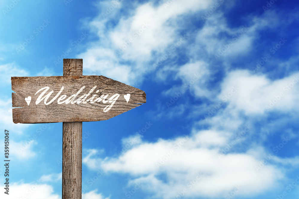 Wooden plaque with inscription Wedding against beautiful blue sky, space for text Wooden plaque with inscription Wedding against beautiful blue sky, space for text