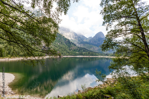 Fototapeta Naklejka Na Ścianę i Meble -  alpine high mountain lake, coniferous woods are reflected in the water, Antrona valley Campliccioli lake, Italy Piedmont