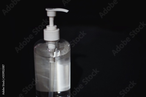 Hand sanitizer bottle with black background.