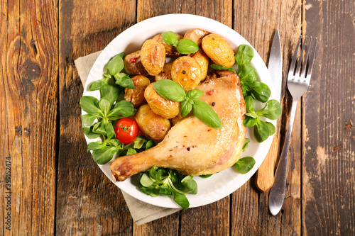 chicken leg with roasted potato and lettuce