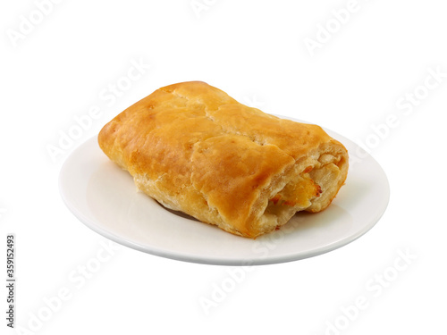 close up single rectangle chicken pie on white ceramic plate isolated on white background, baked homemade puff pastry typically stuffed meat or vegetables