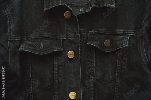 Close up of black jeans jacket fabric.