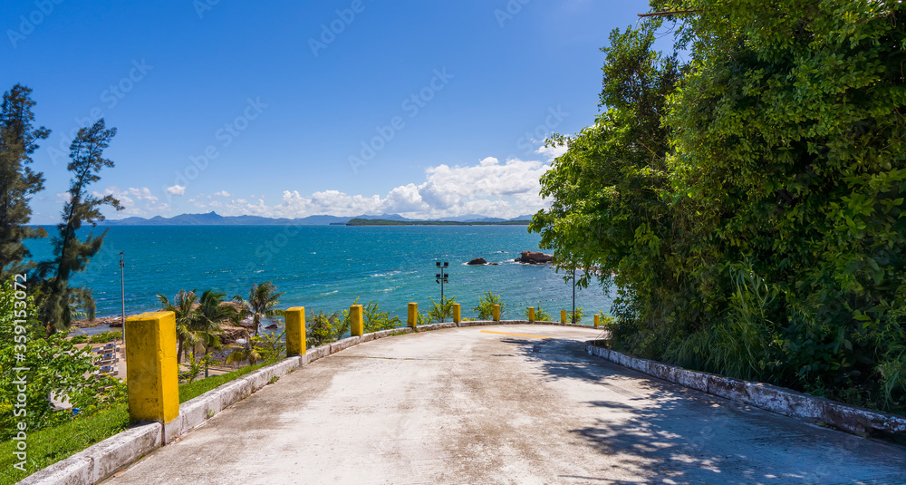 scenic road beside deep blue sea