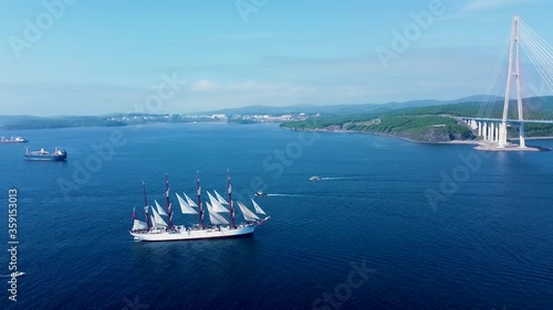 Top view. The training sailing ship Bark Sedov passes by the Russky Island to the Russian Bridge in Vladivostok in good weather. photo