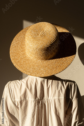 Foto Young pretty woman in straw hat and white dress / sundress