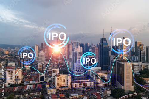 Hologram of IPO glowing icon, sunset panoramic city view of Kuala Lumpur. KL is the financial hub for transnational companies in Malaysia, Asia. The concept of boosting the growth by IPO process.