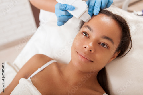 Photography Young African woman getting facial treatment