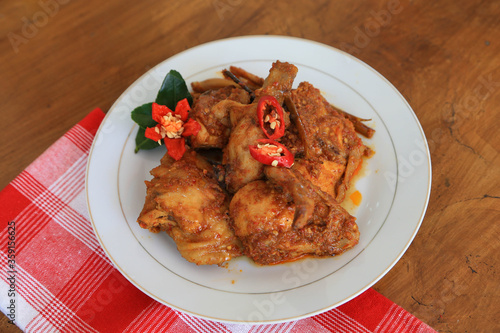 Photos of chicken food cooked spicy and served on a plate